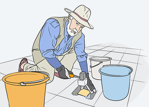 Gunter Demnig verlegt einen Stolperstein auf einem Gehweg.